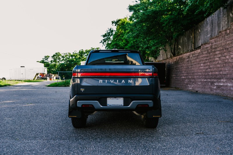 Rally Armor 22-24 Rivian R1T Black UR Mud Flap w/Tangerine Scream Logo