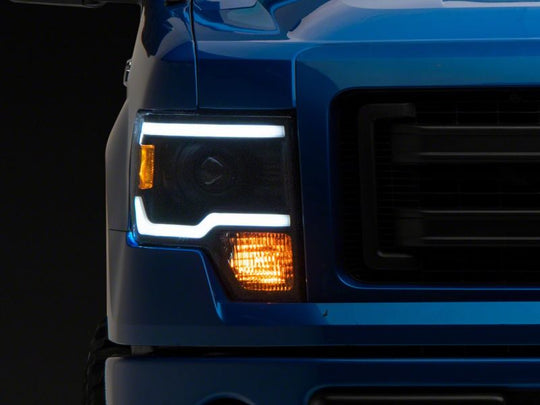 Raxiom 09-14 Ford F-150 Axial Series Projector Headlights w/ LED Light Bar- Blk Housing (Clear Lens)