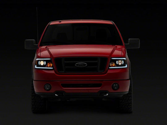 Raxiom 04-08 Ford F-150 Axial Series Projector Headlights w/ SEQL LED Bar- Blk Housing (Clear Lens)